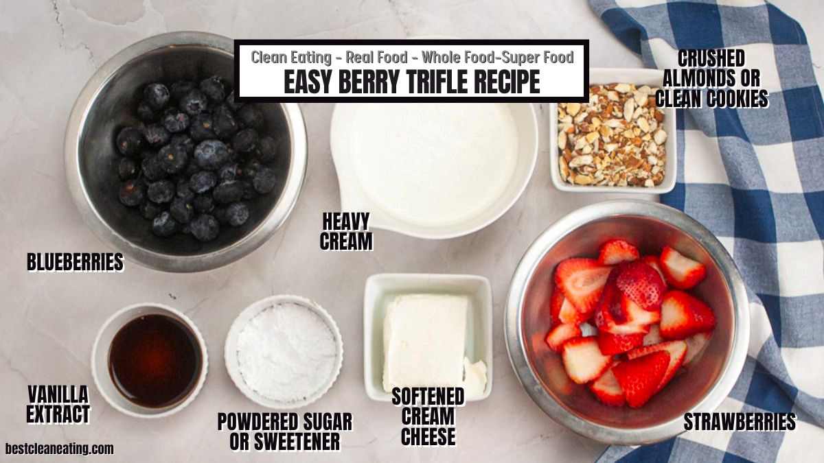 Top-down view of ingredients for an easy berry trifle recipe, including blueberries, strawberries, heavy cream, cream cheese, powdered sugar, vanilla extract, and crushed almonds.