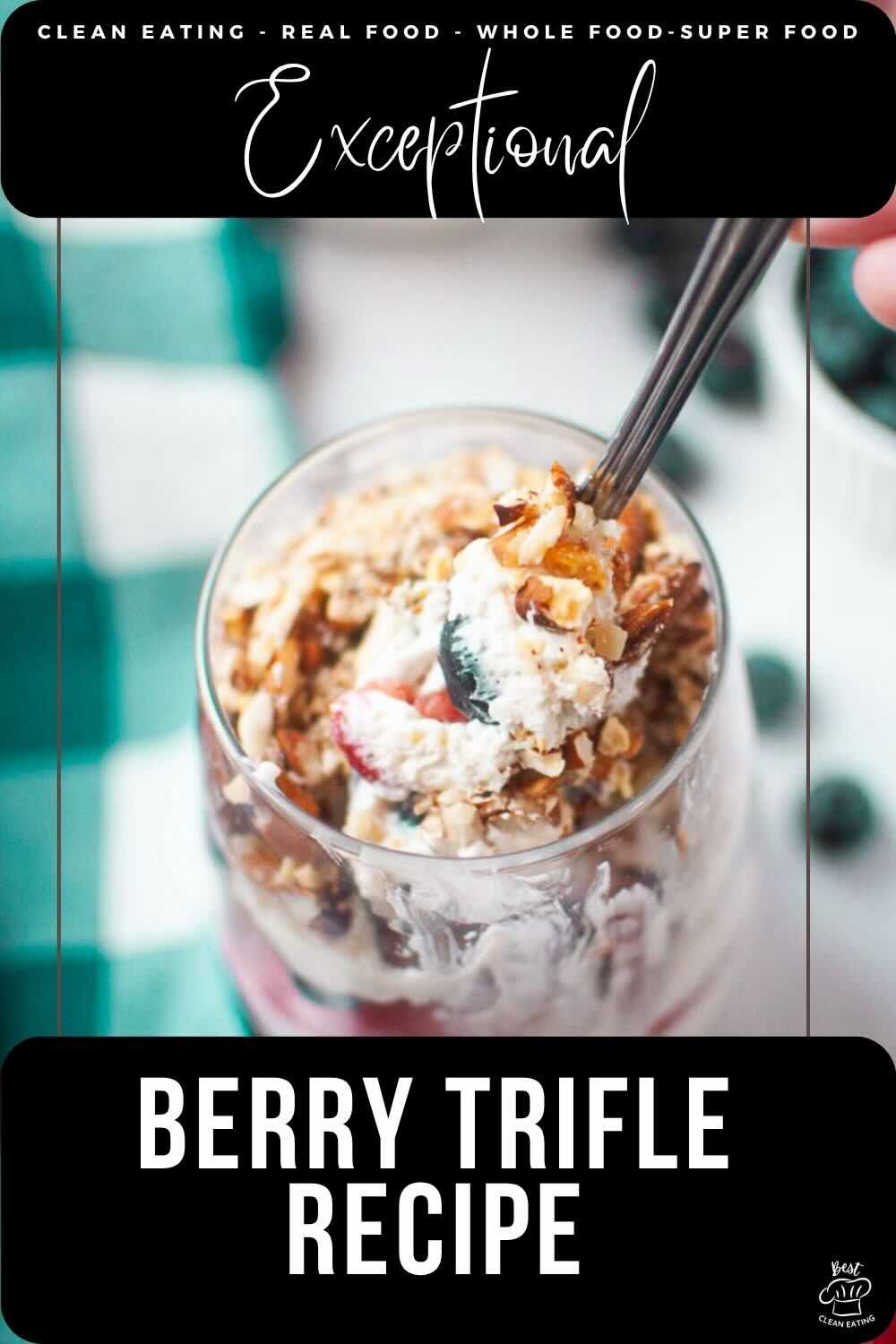 A glass of berry trifle topped with granola, cream, and berries, with a spoon scooping a bite. Text overlay reads "Berry Trifle Recipe.
