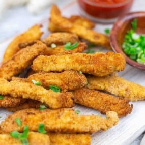 Air fried chicken strips garnished with green onions.