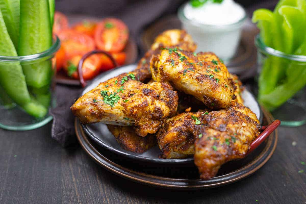 Air fried chicken wings with cucumbers tomatoes.