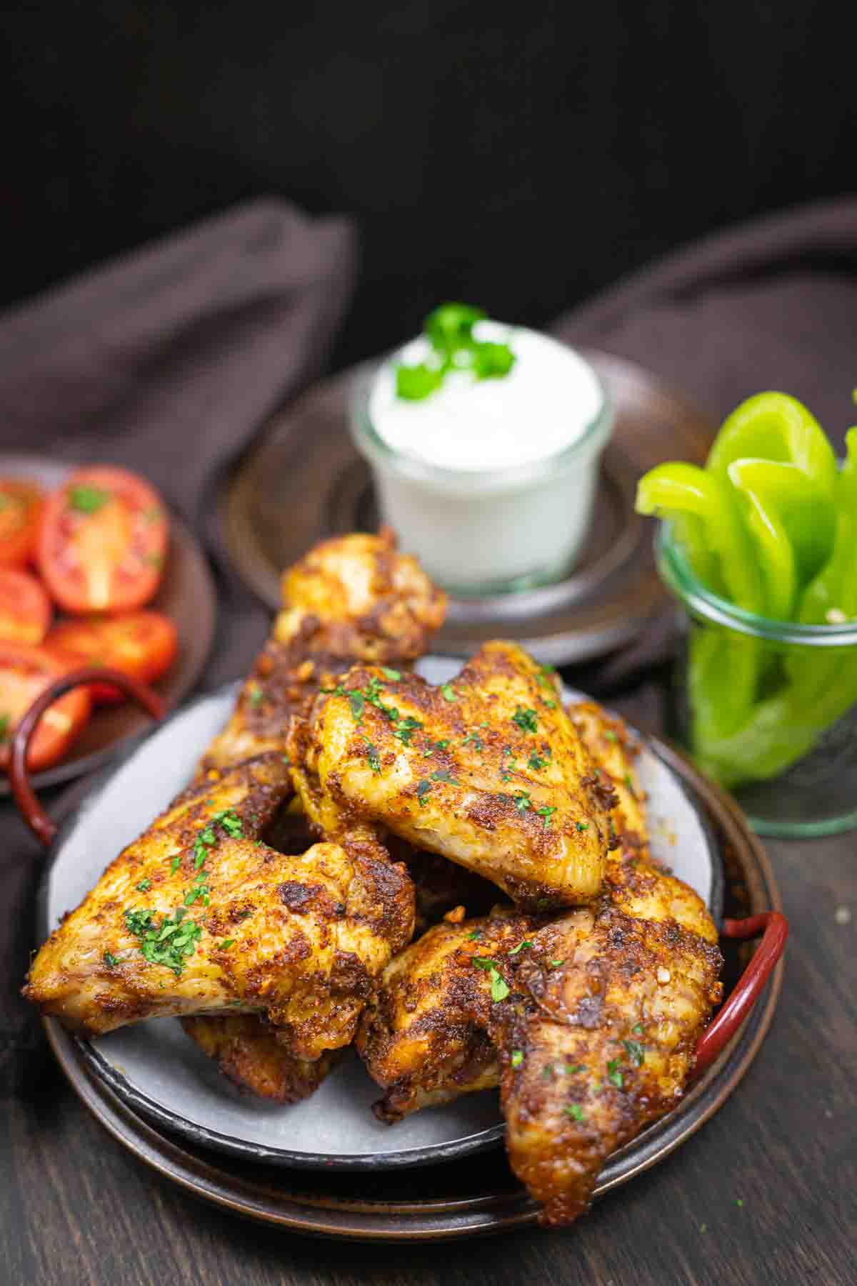Whole chicken wings served with dip and vegetables.
