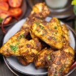 Juicy chicken wings seasoned and garnished parsley.