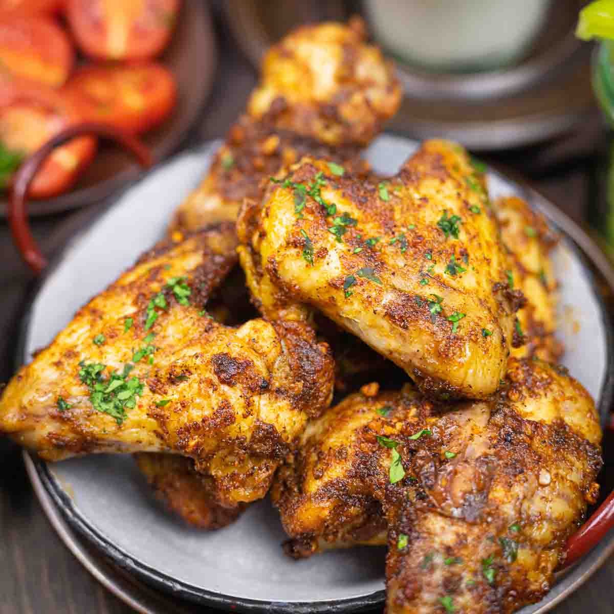 Juicy chicken wings seasoned and garnished parsley.