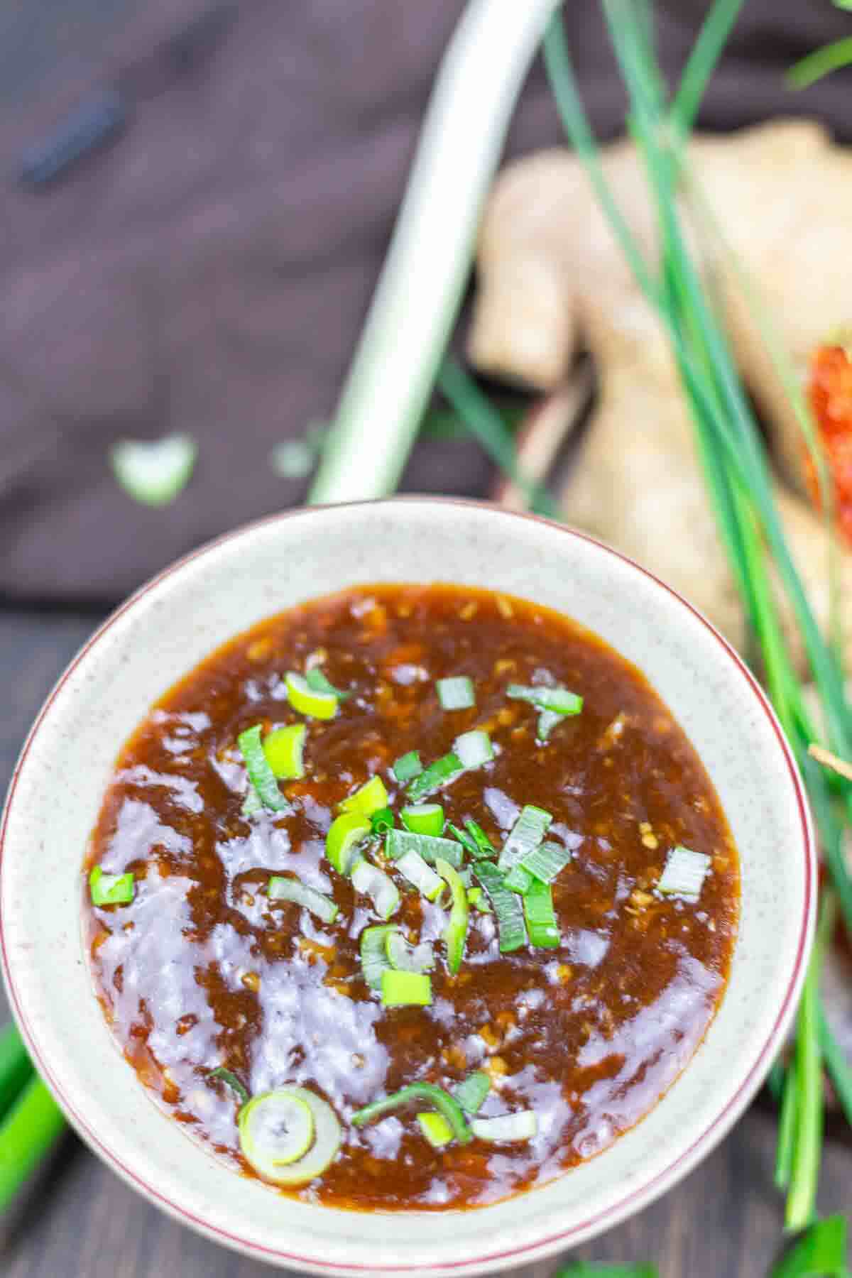 Asian garlic sauce garnished with green onions.