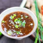 Bowl of chilli garlic sauce with scallions.