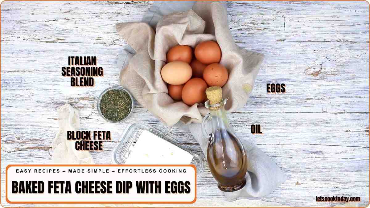 A bowl of eggs, a bottle of oil, a block of feta cheese, and a jar of Italian seasoning blend are arranged on a rustic white surface.