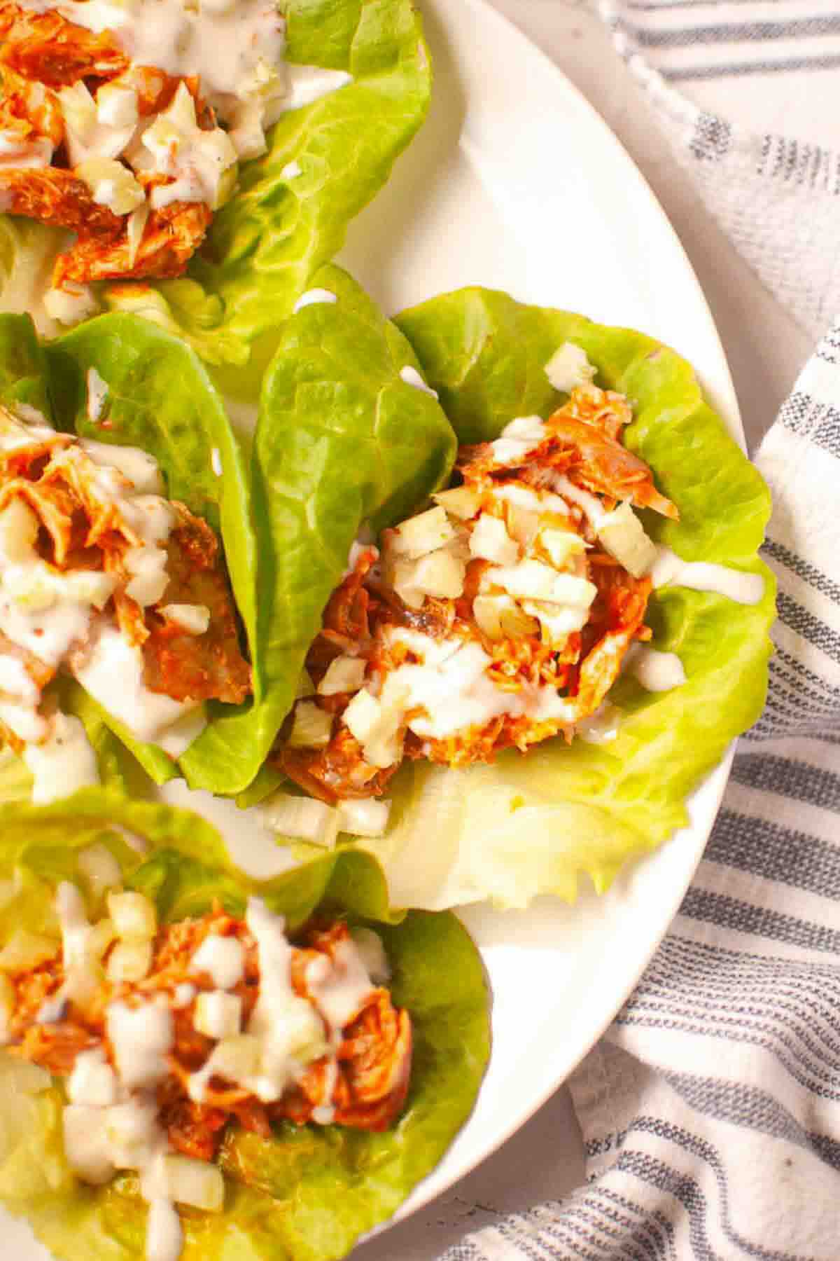 Plate of buffalo chicken lettuce wraps served.