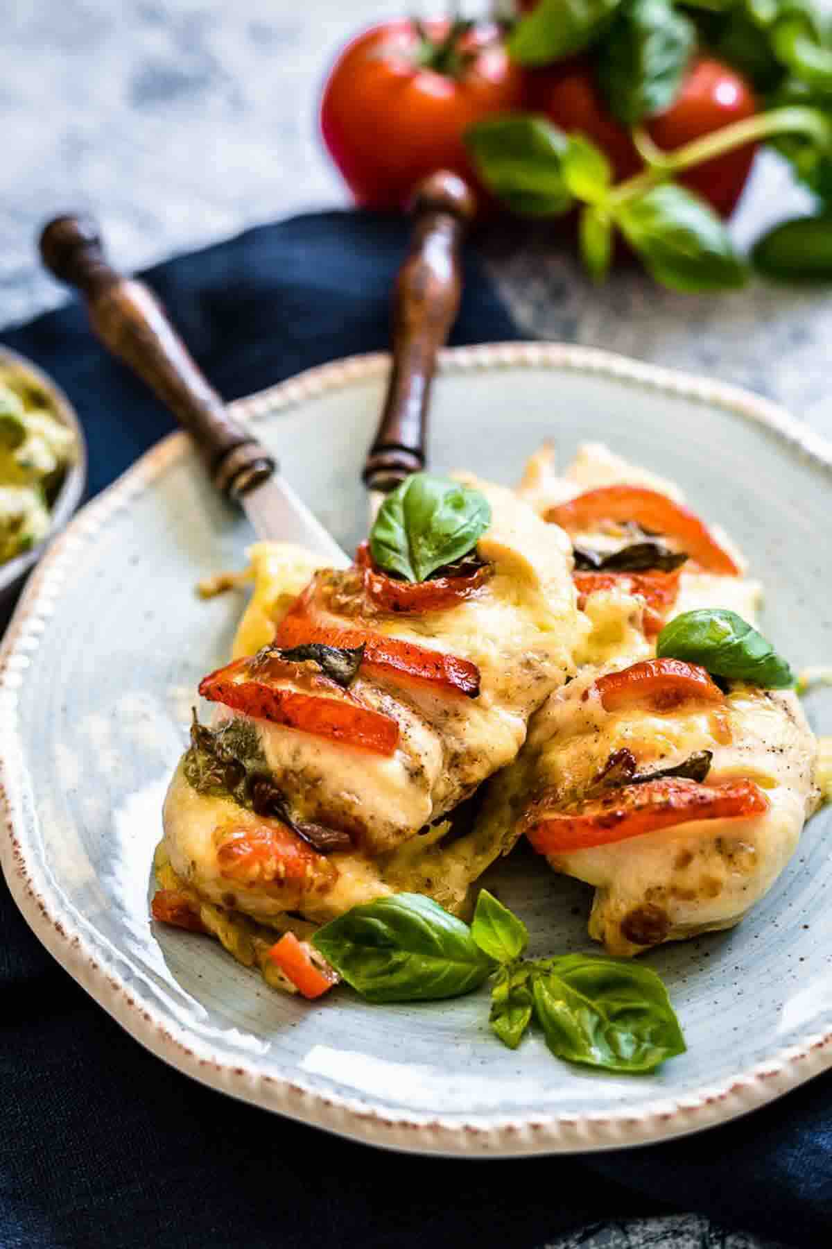 Juicy stuffed chicken topped with tomato slices.