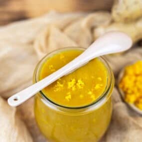 Orange chicken sauce in glass jar closeup.