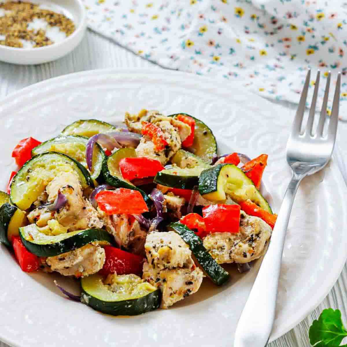 Classic Italian chicken and vegetables on white plate.