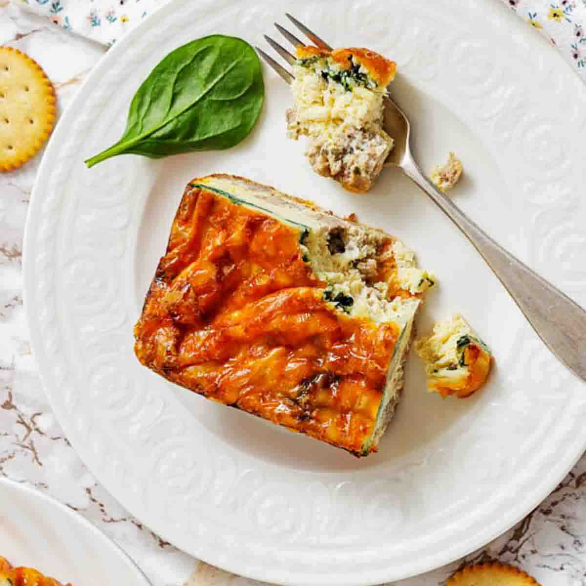 Cheesy sausage egg strata with spinach slice.