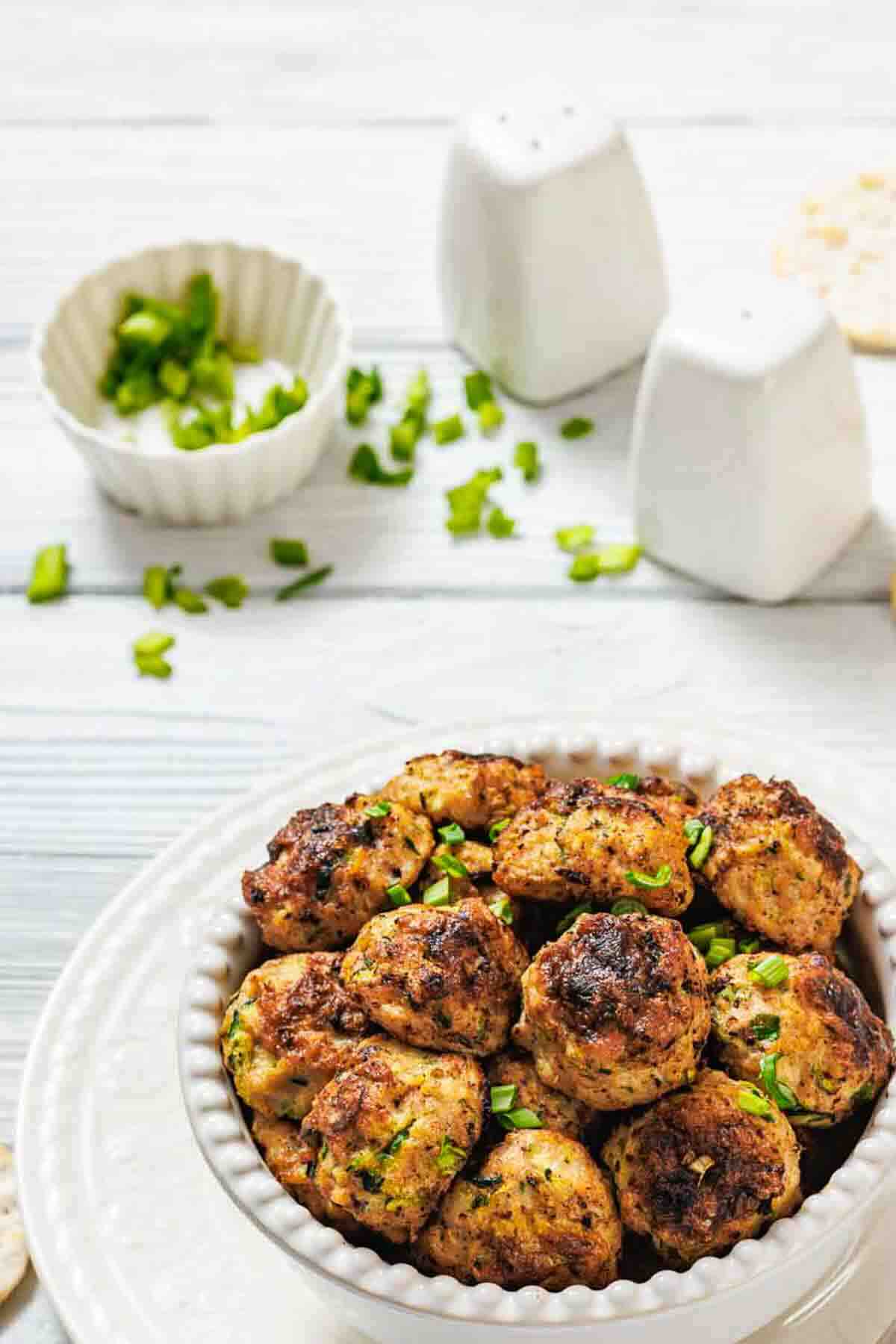 Overhead view of zucchini chicken fritters bowl.
