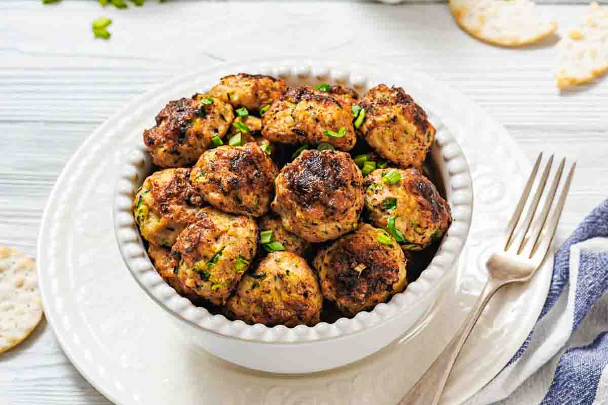 Chicken fritters topped with chopped green onions.