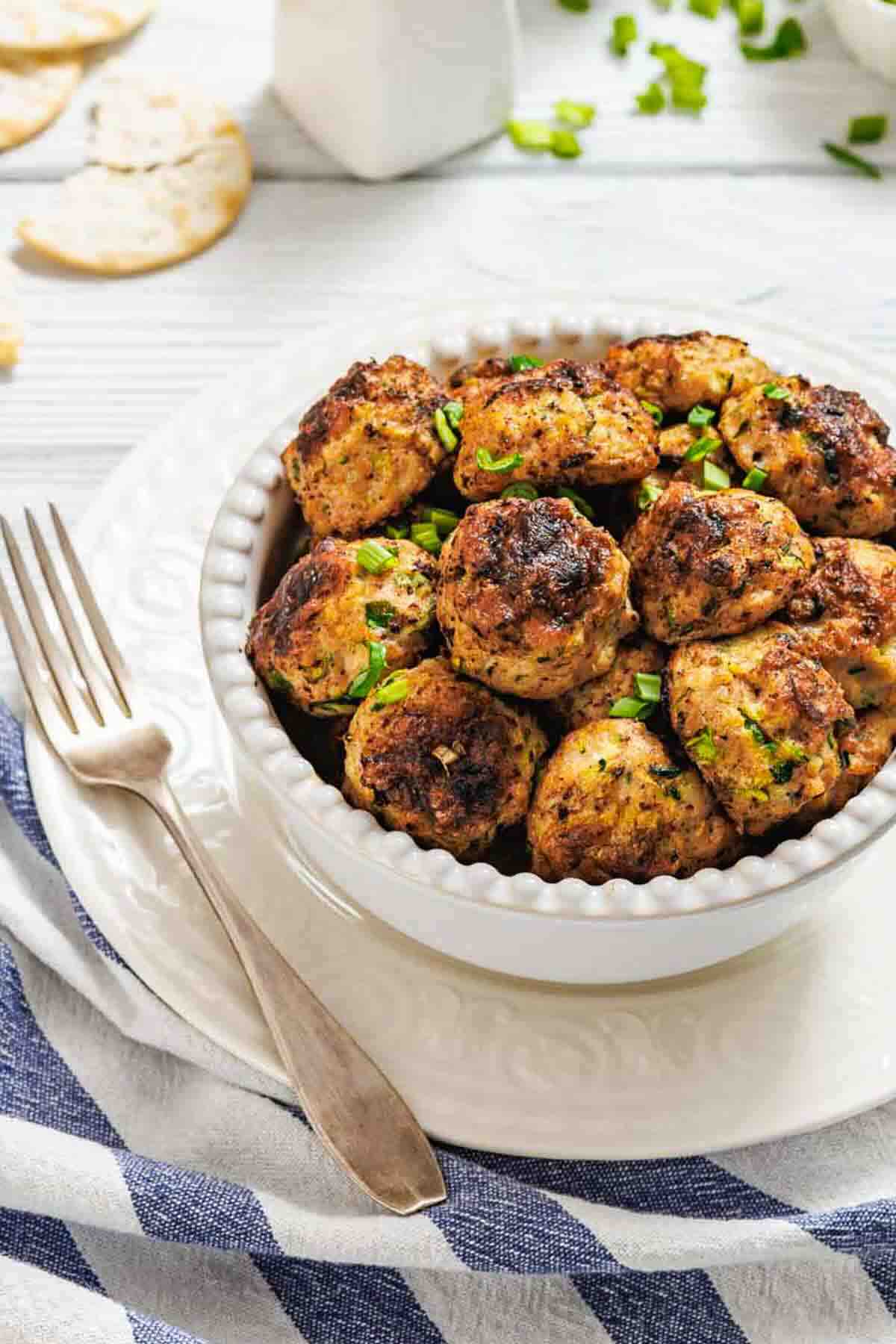 Bowl of fritters with herbs and salt.