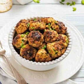 Bowl of chicken fritters with fork beside.