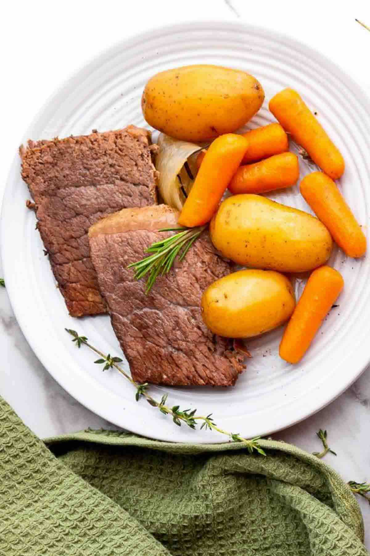 Rump roast slices with carrots and potatoes.