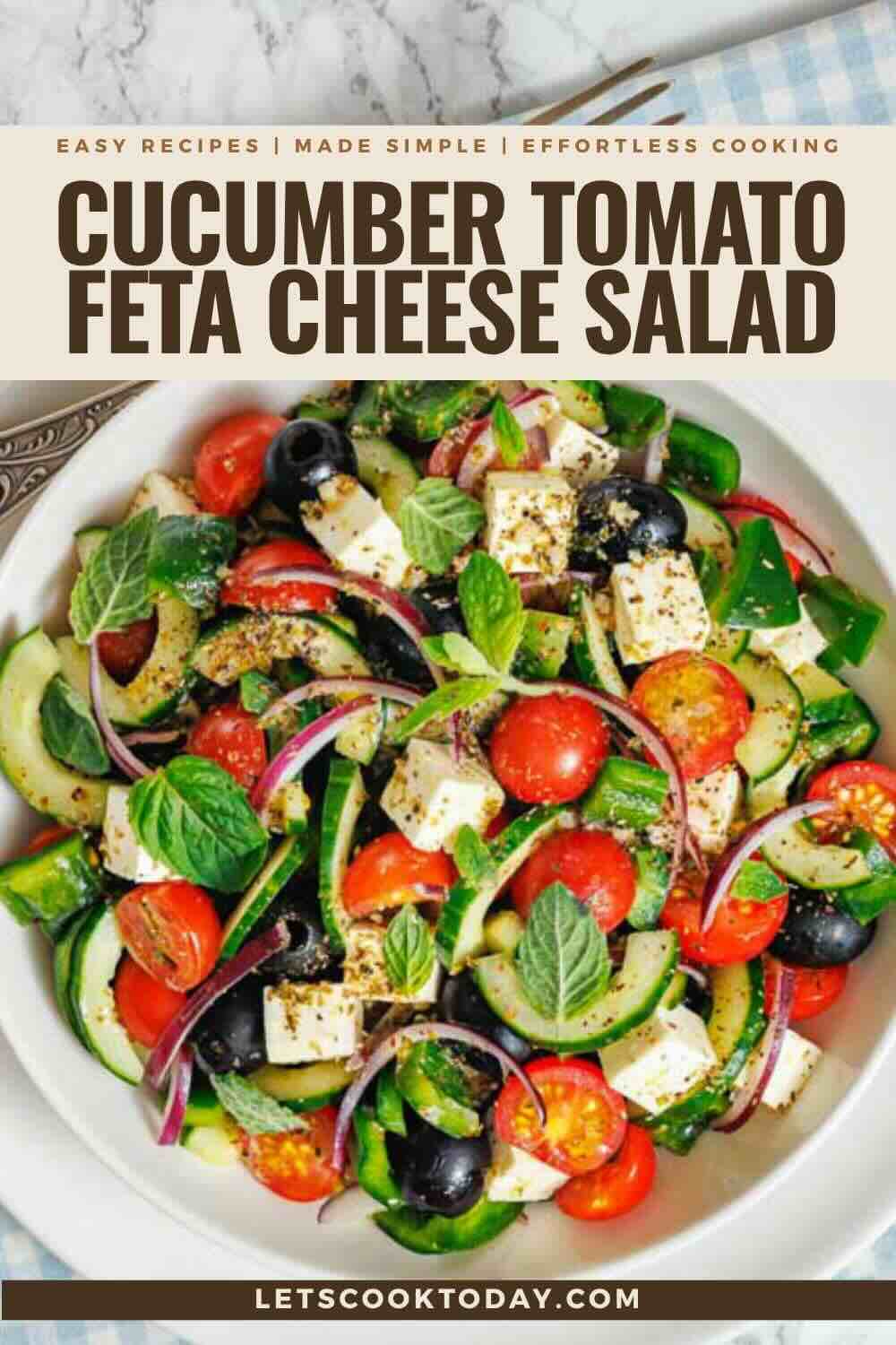 Colorful cucumber tomato salad with feta cubes.