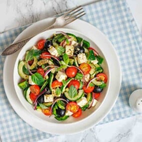 Summer salad with cucumbers tomatoes olives and feta.