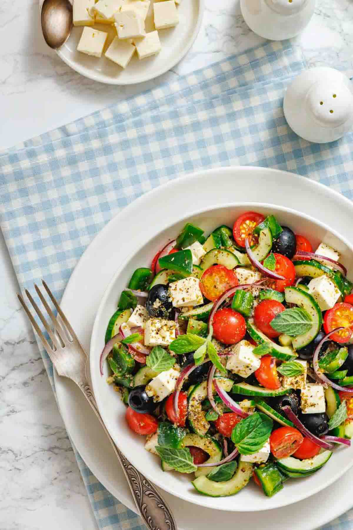 Greek-inspired salad with tomatoes cucumbers and feta.