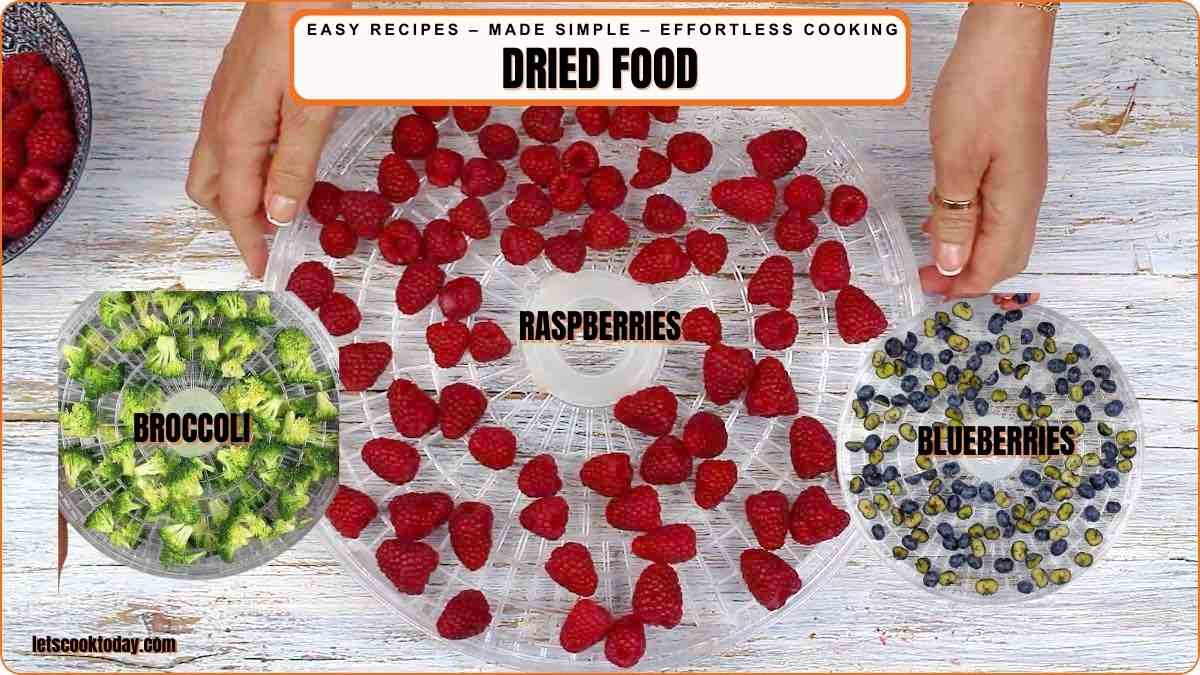 Broccoli raspberries and blueberries arranged for dehydrating.