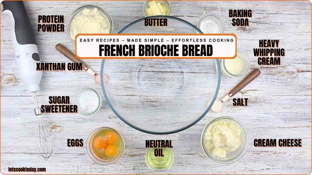 A glass mixing bowl surrounded by labeled ingredients for French brioche bread, including eggs, oil, butter, cream cheese, xanthan gum, and sweetener.