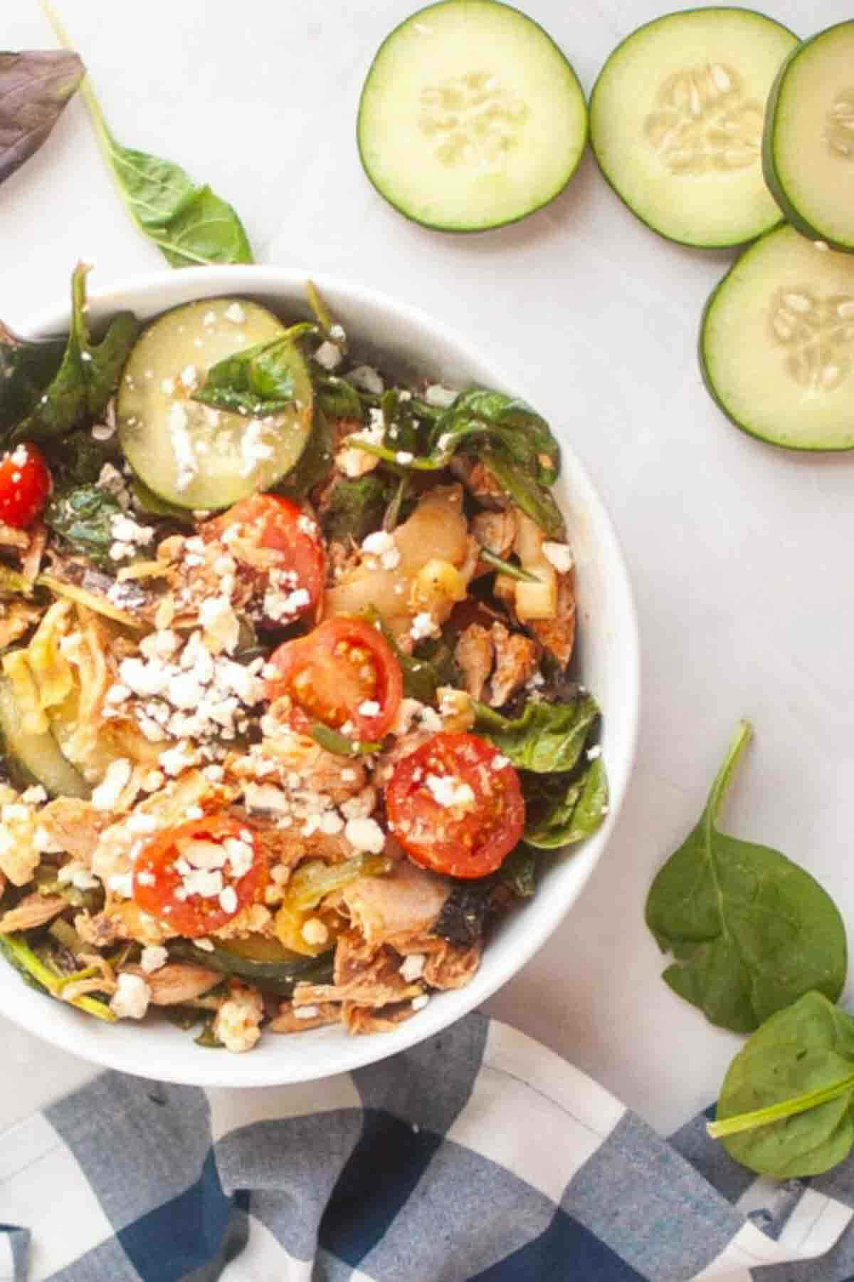 Fresh buffalo chicken salad with sliced cucumbers.