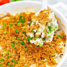 Fried pickle dip casserole surrounded by ingredients.