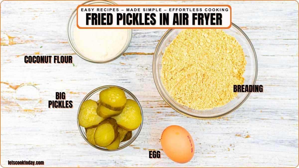 Top view of ingredients for air fryer fried pickles: a bowl of coconut flour, breading, sliced pickles, and a whole egg on a white background.