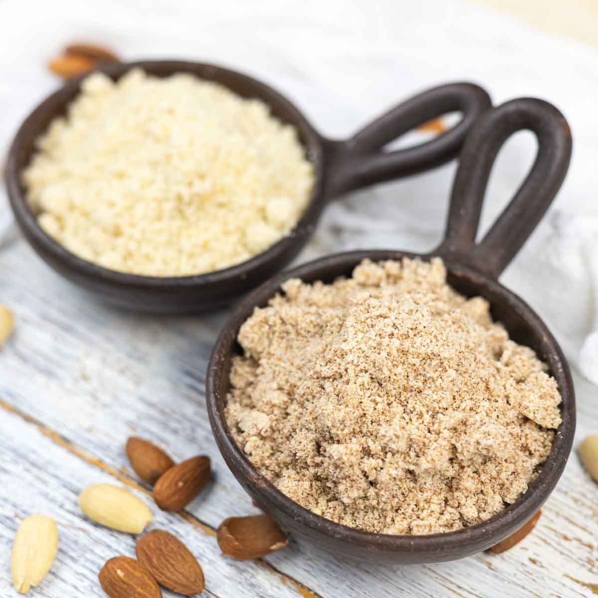 Two bowls comparing almond flour and meal.