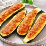 Baked zucchini halves topped with ground meat.