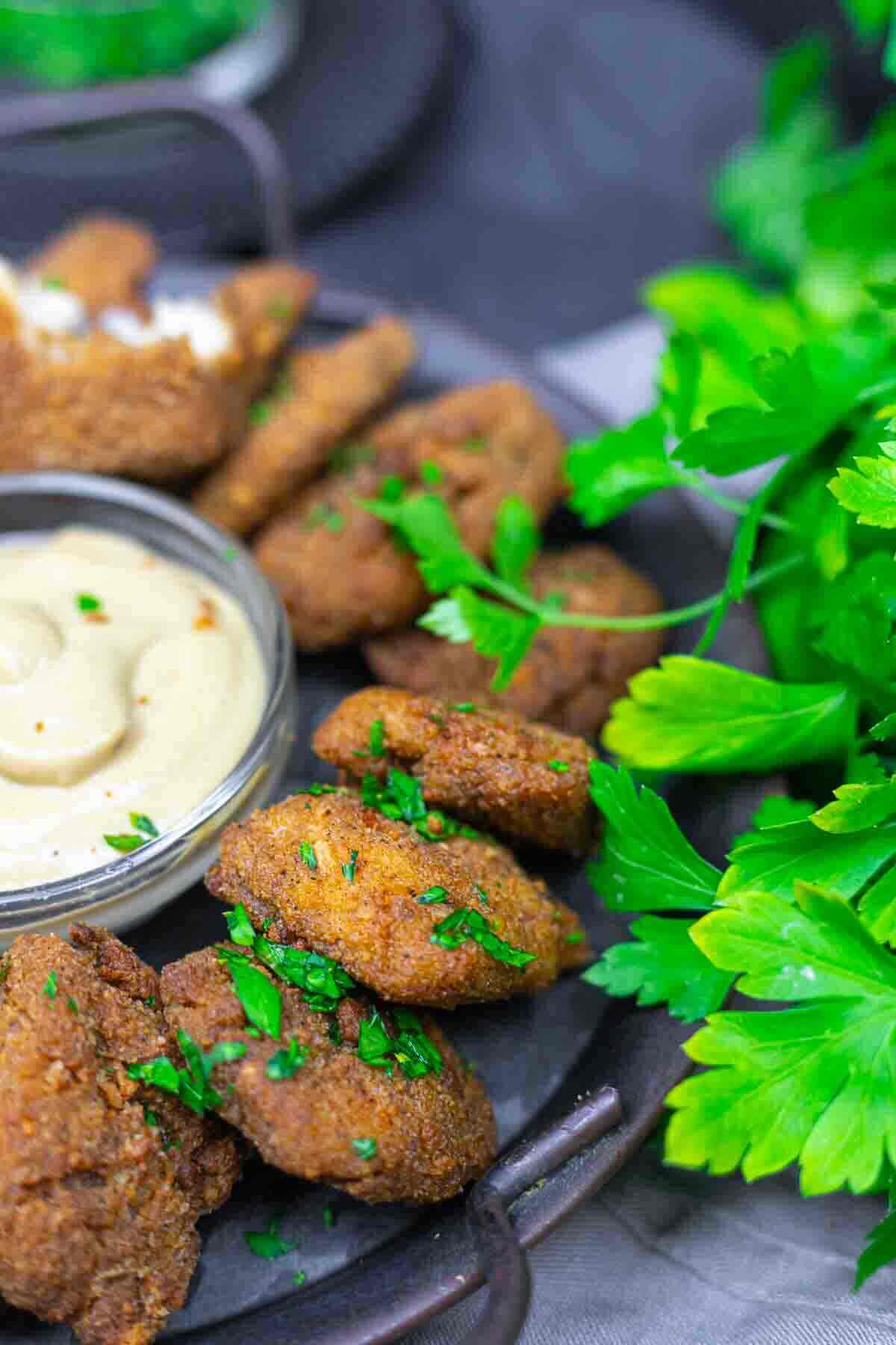 Fried ground chicken nuggets with dipping sauce.