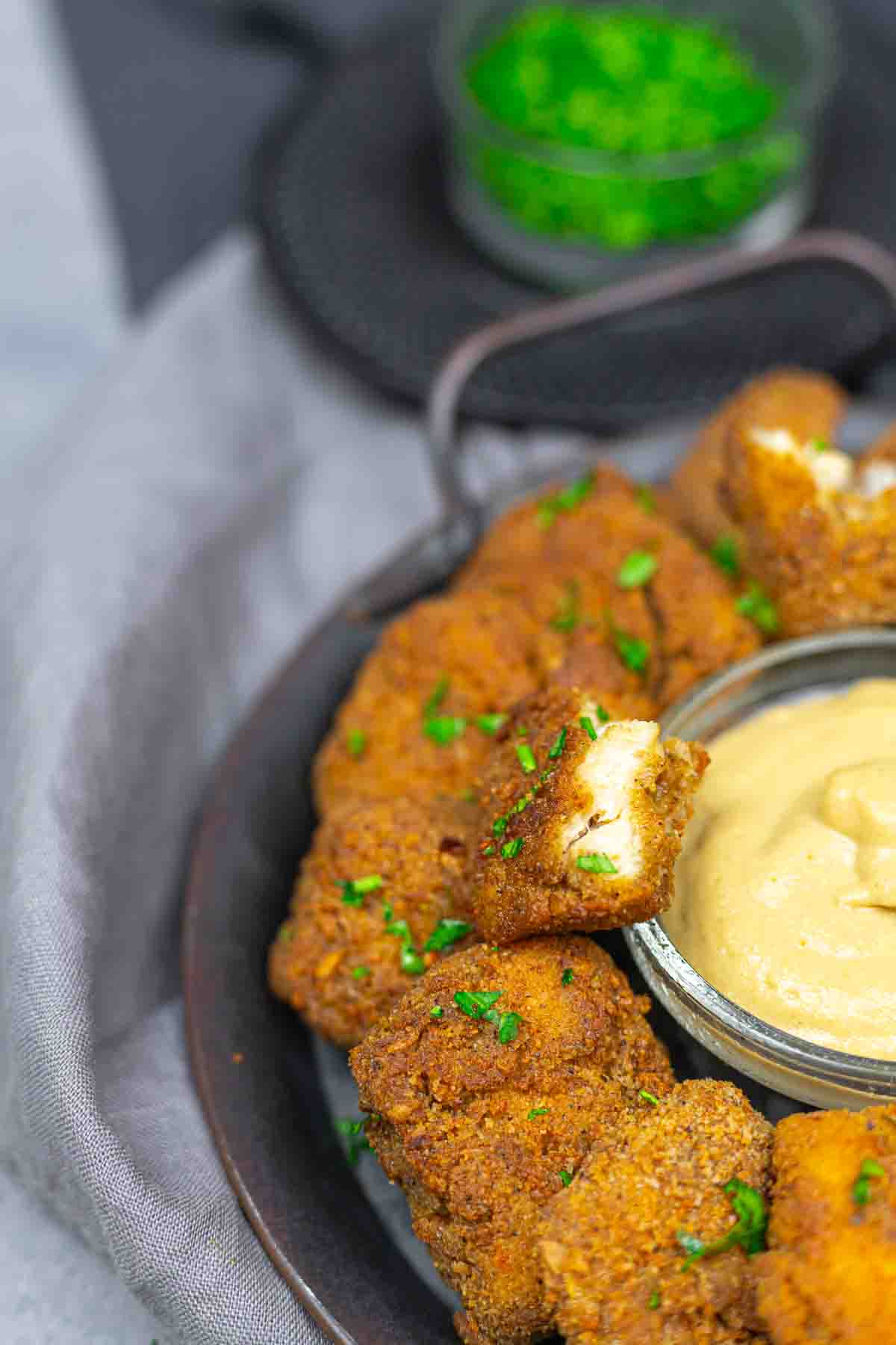Golden ground chicken nuggets with dipping sauce.