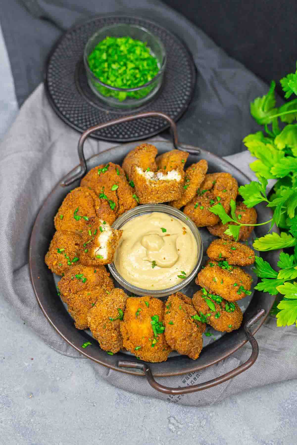 Overhead view of chicken nuggets and parsley.