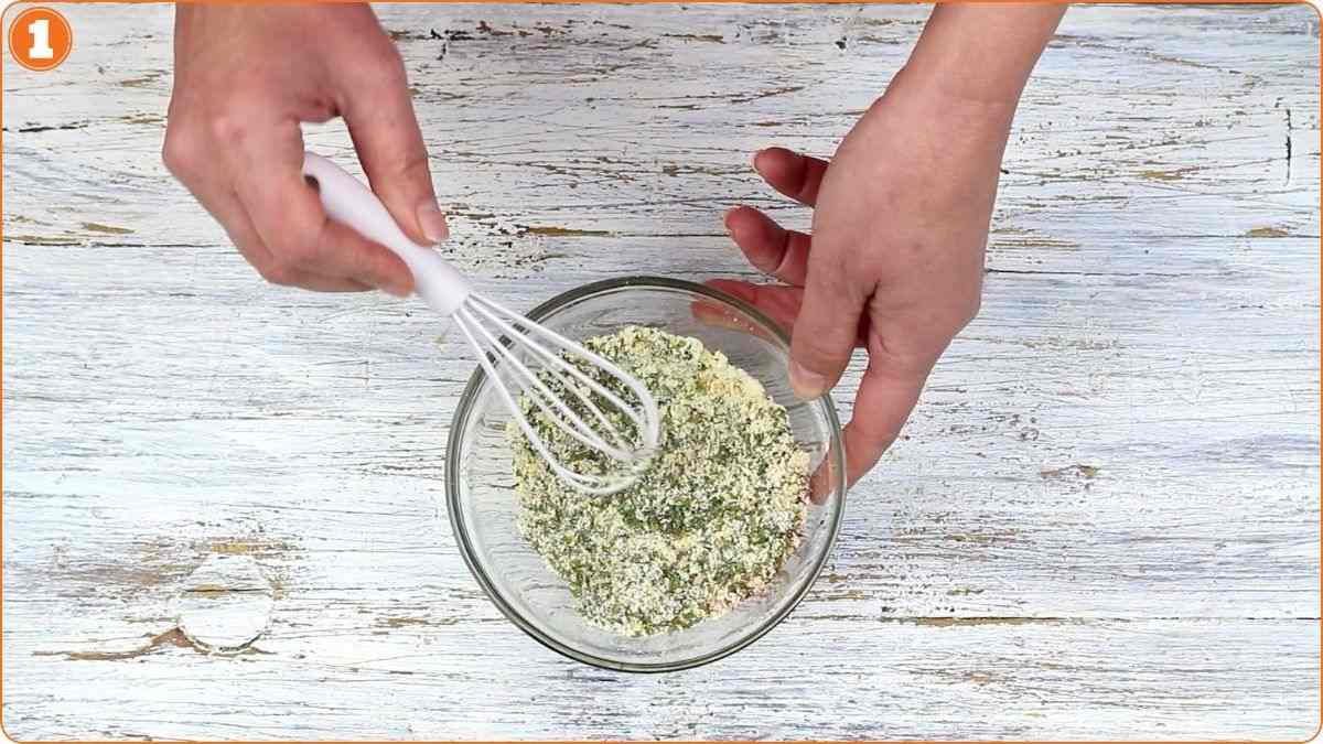 Hands whisking homemade ranch seasoning mixture.
