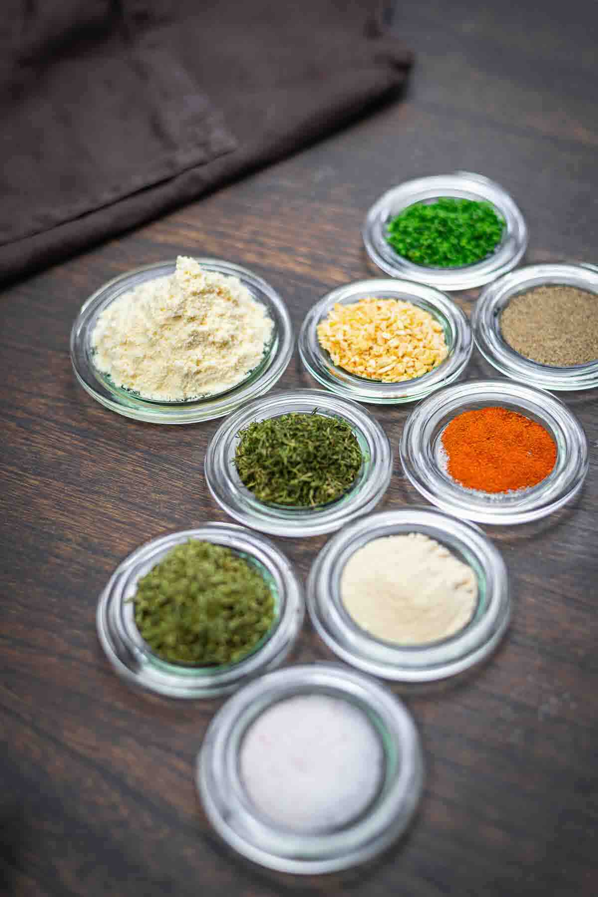 Variety of herbs and powders in bowls.