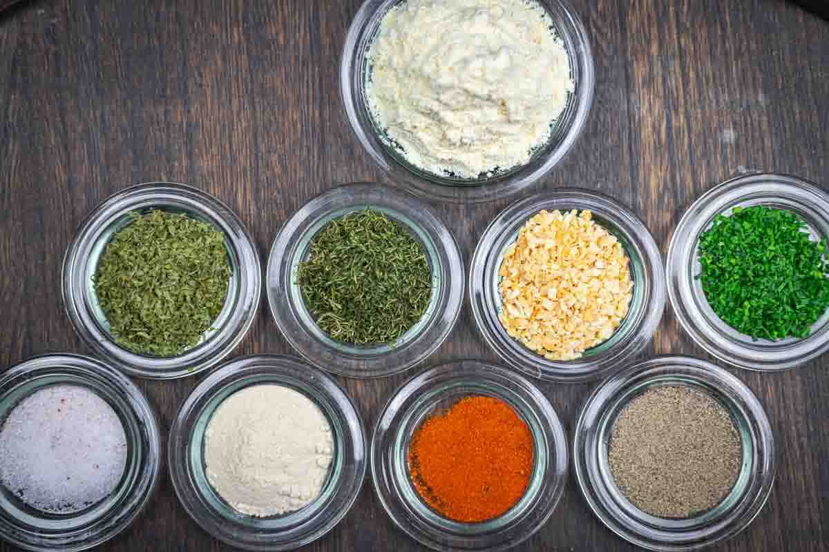 Dried herbs and seasonings arranged neatly in bowls.