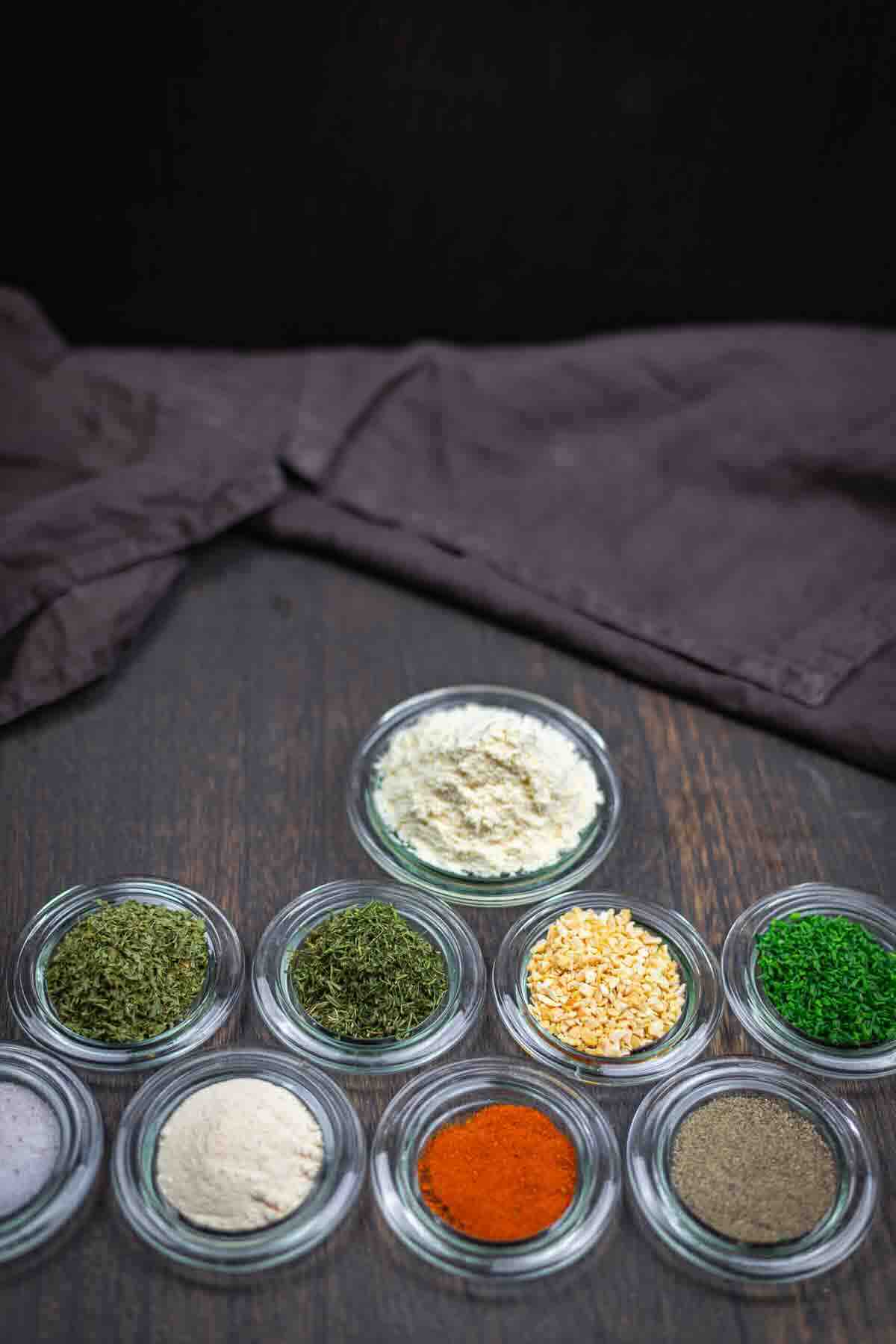 Glass bowls with spices and dried herbs.