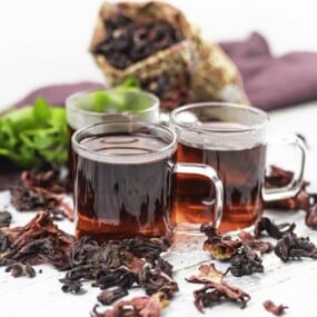 Three glass mugs of hot sorrel tea.