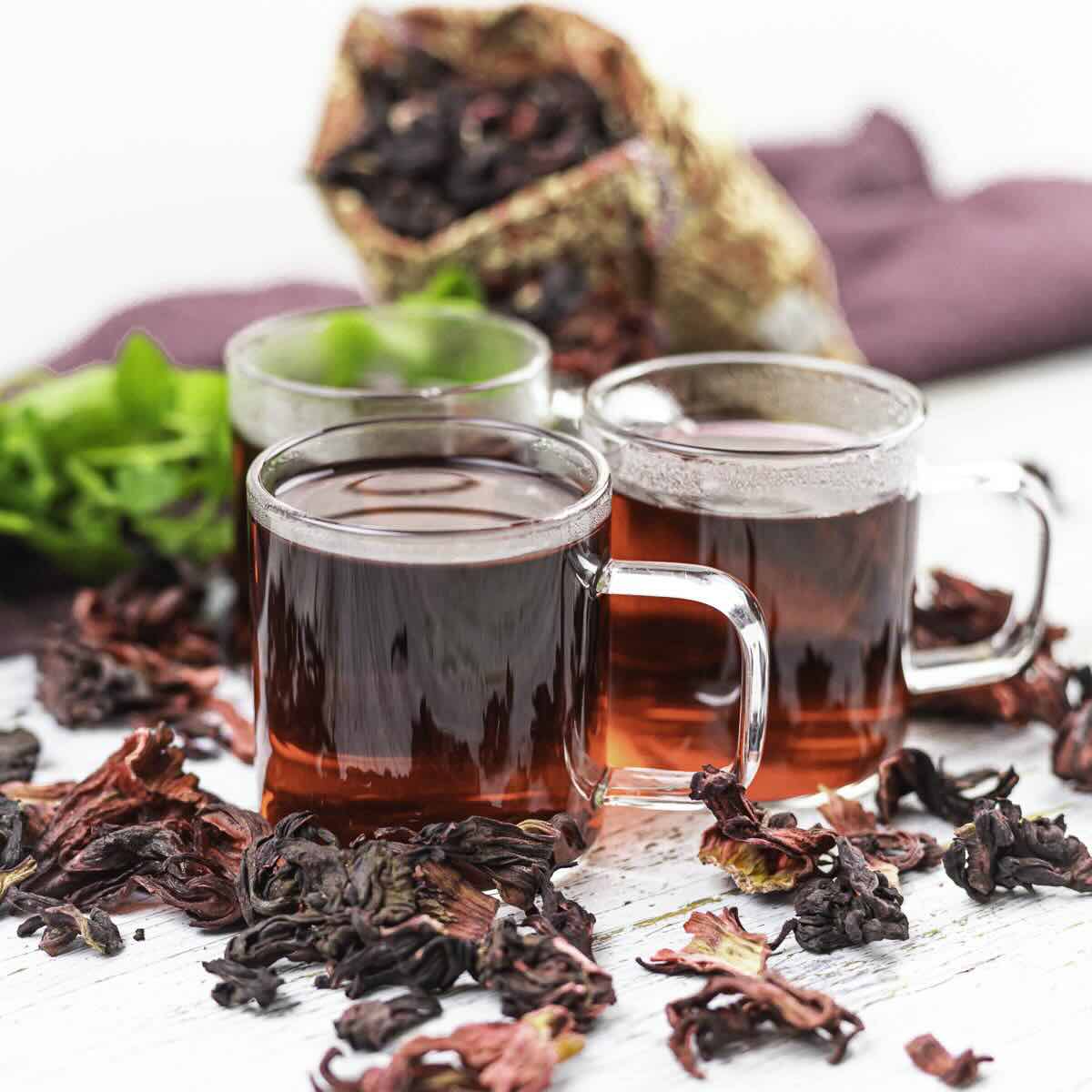 Three glass mugs of hot sorrel tea.