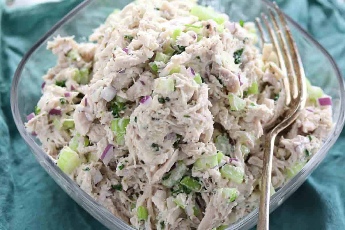 Chicken salad served in clear glass bowl.