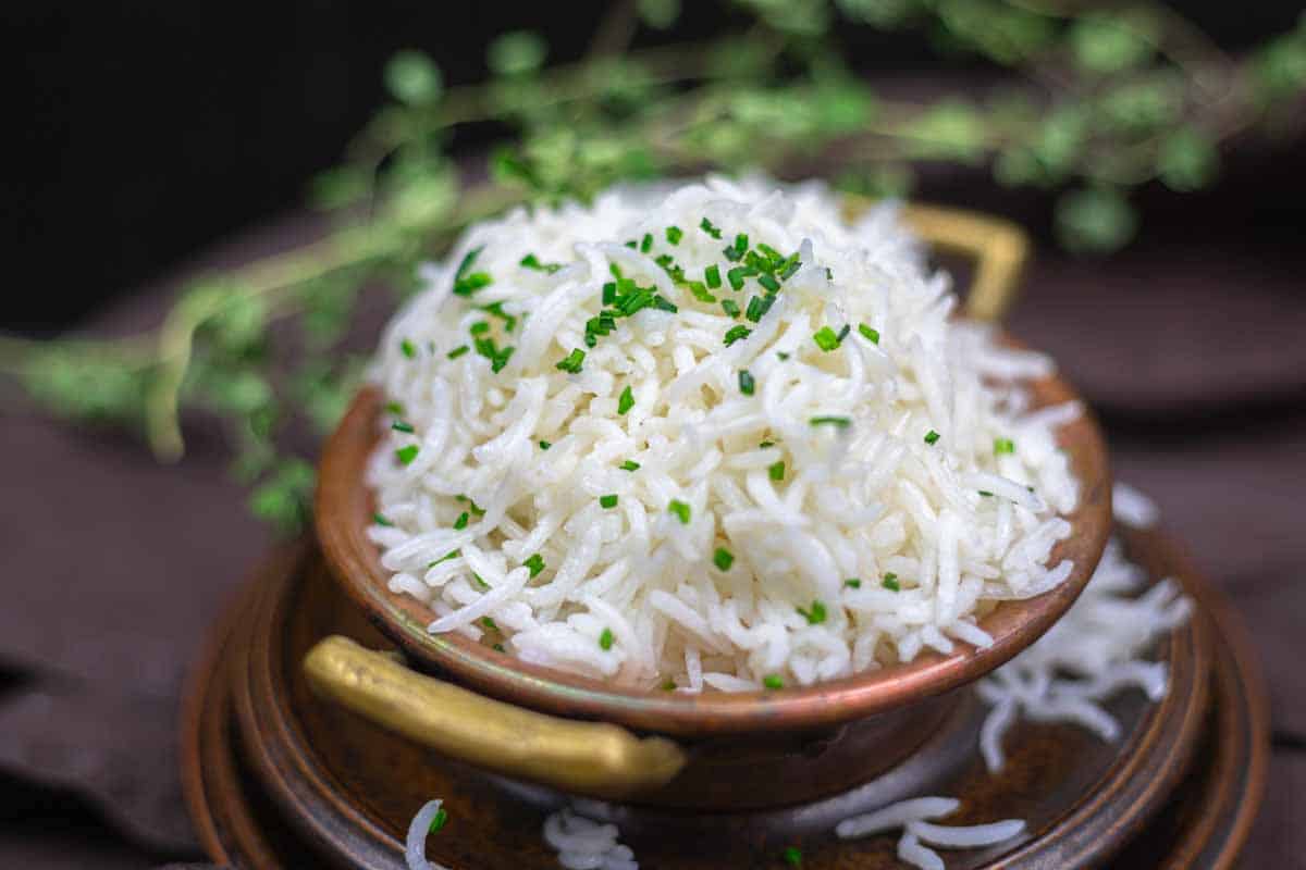Perfectly cooked oven rice with herbs garnish.