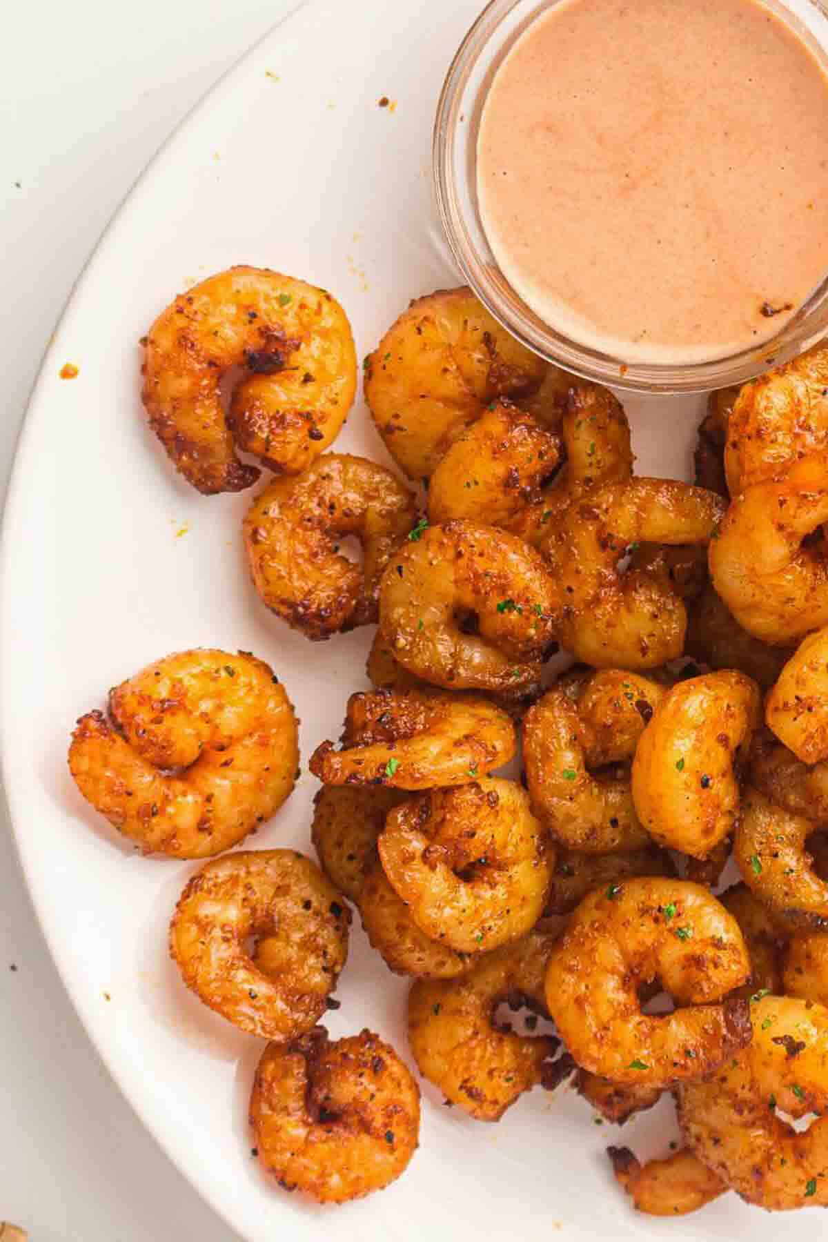 Air fried shrimp with sauce in a small bowl.