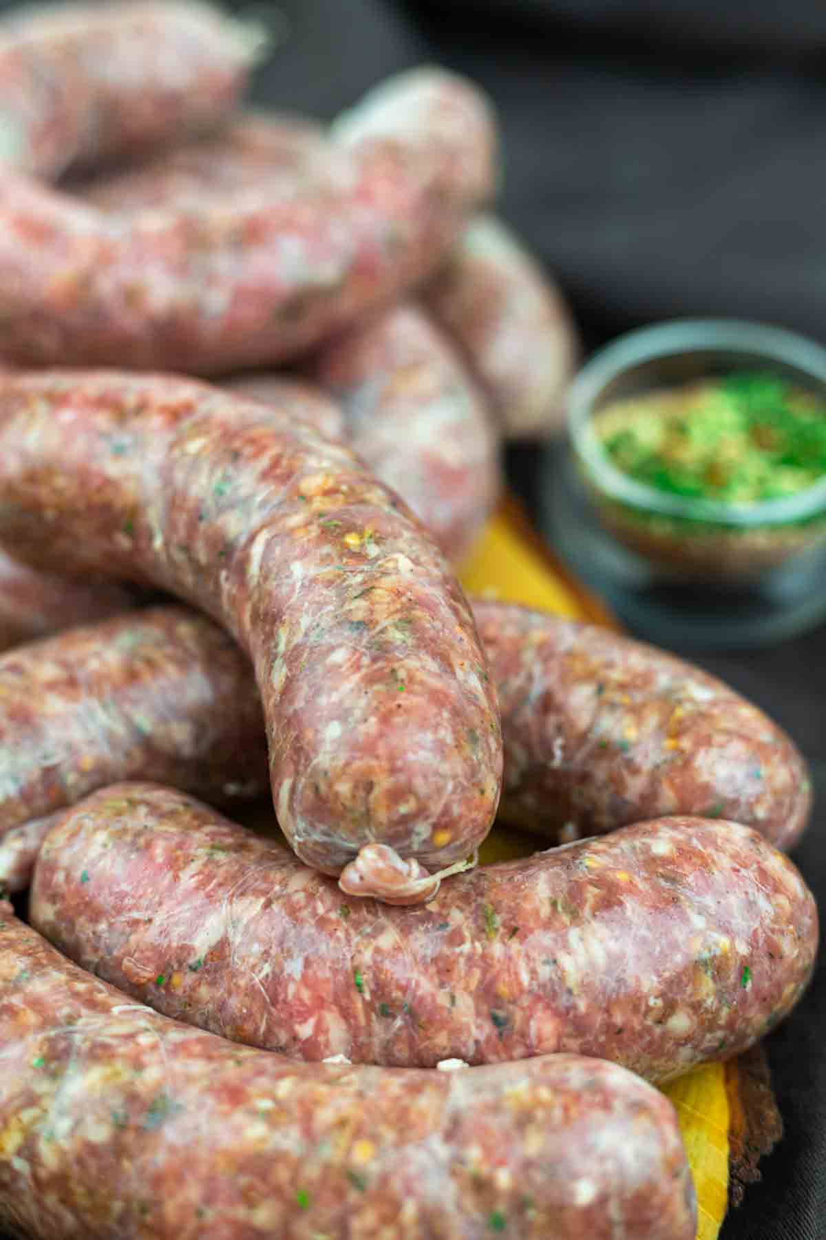 Homemade sausage links displayed on cutting board.