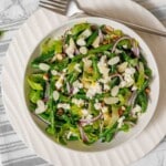 Bowl of green beans feta and almonds.