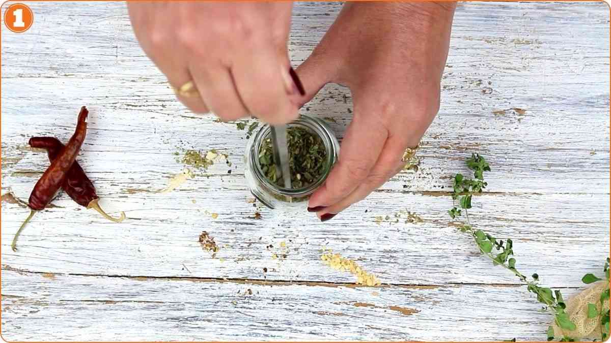 Stirring homemade Italian seasoning mixture together.