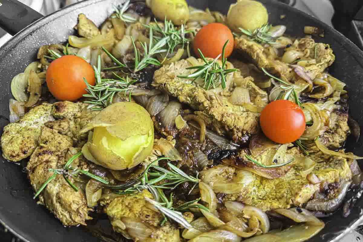 Pork cutlets cooked with onion and rosemary.