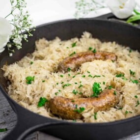Juicy sausage baked with sauerkraut and herbs.