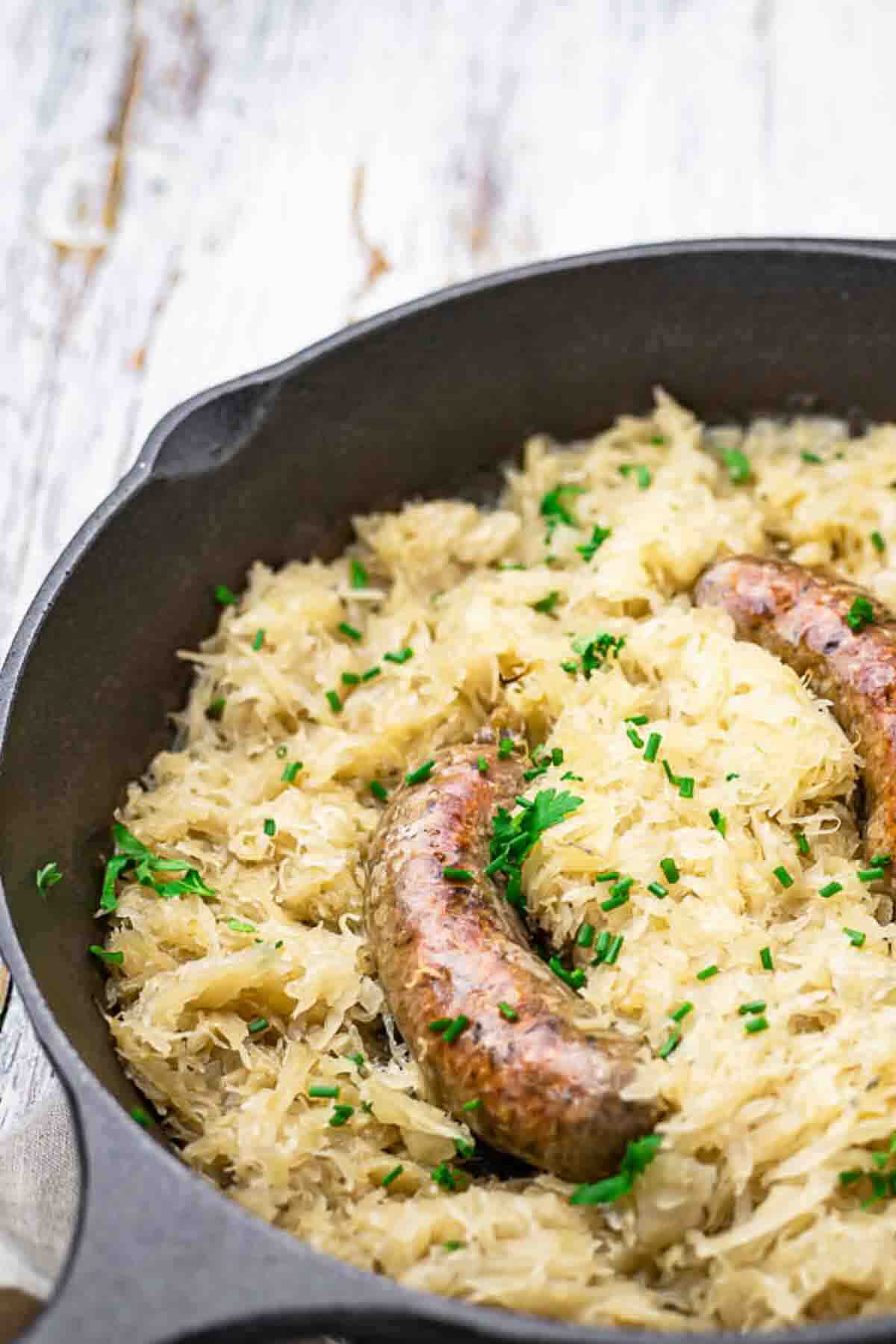 Homemade baked sausage nestled in tangy sauerkraut.