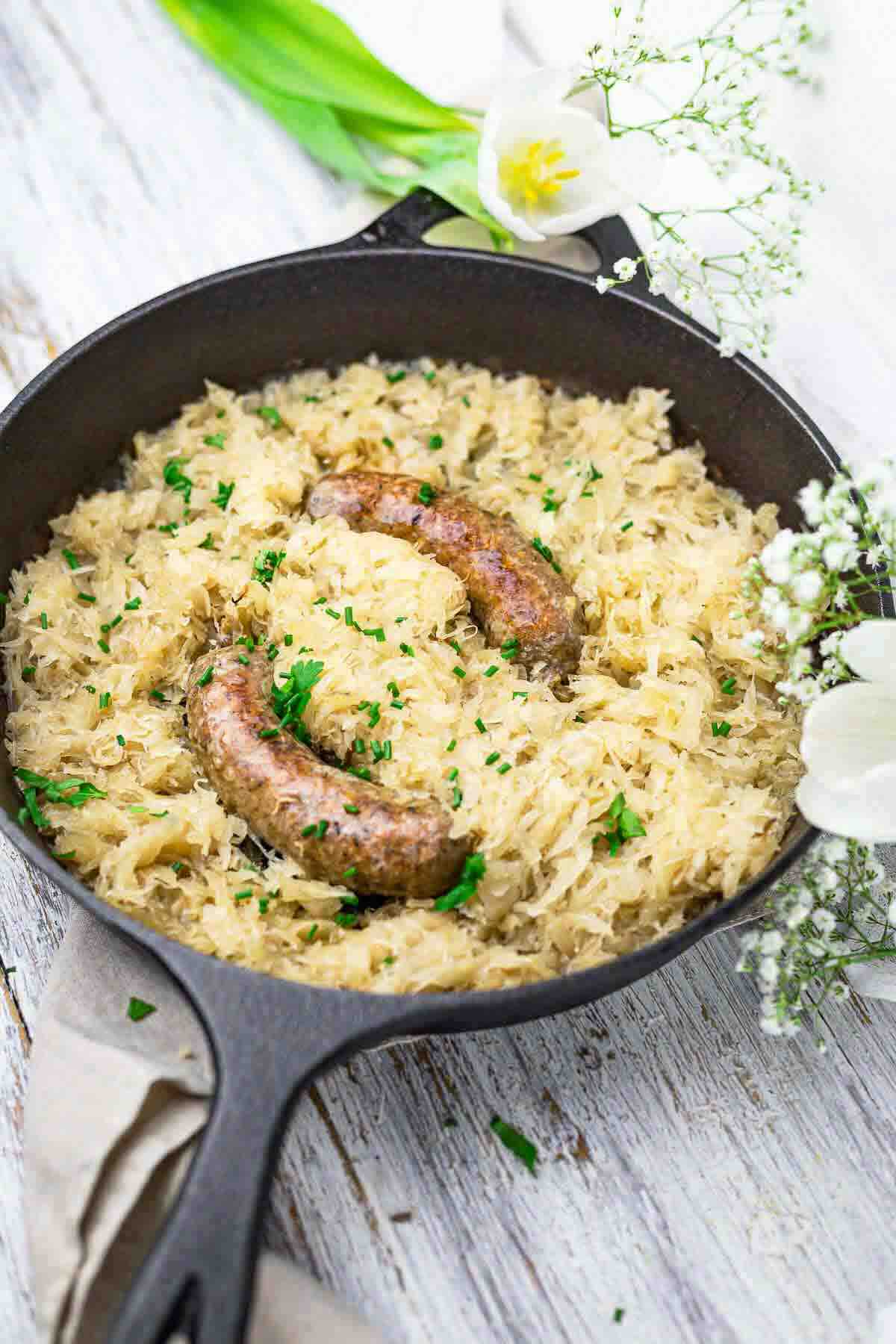 Oven baked sausage served with sauerkraut topping.