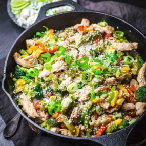 Cast iron pan with chicken and veggies.